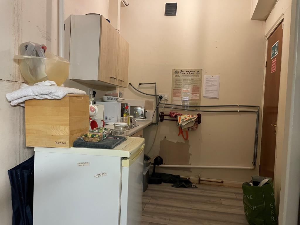 Lot: 79 - FREEHOLD SHOP AND FLAT WITH UPPER PARTS - kitchen at rear with fire door to rear flat